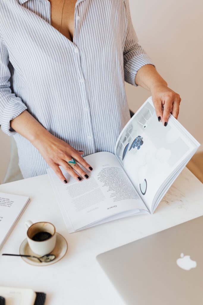 A woman paying attention to work and reading a book